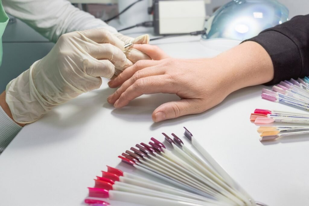Nail technician applying nail art