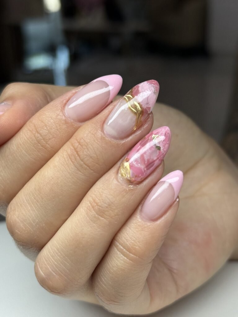 Russian manicure with pink French tips and gold-foil marble accents at Nailbox Co.